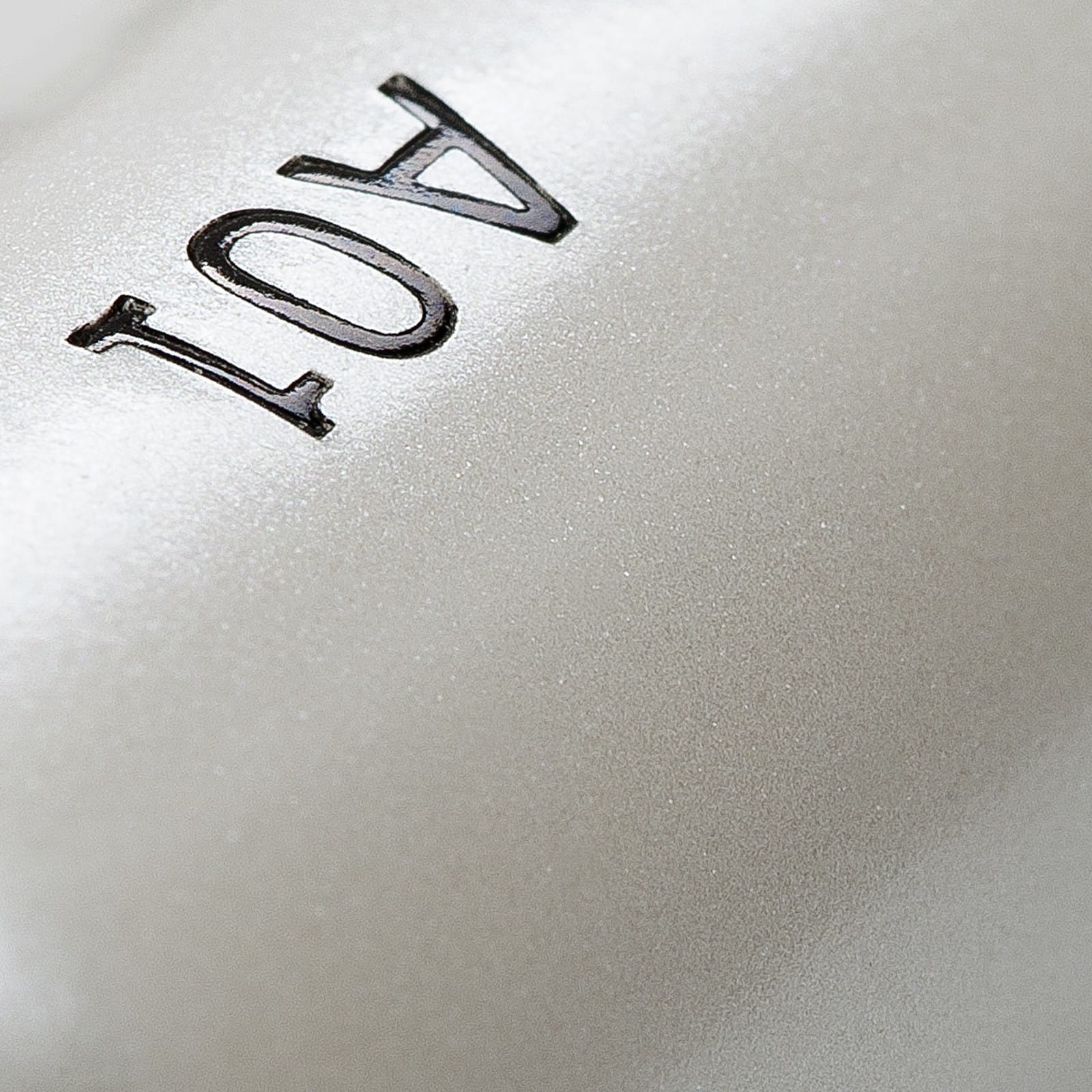 Close-up of a silver eyeliner brush handle with "401" imprinted on it.